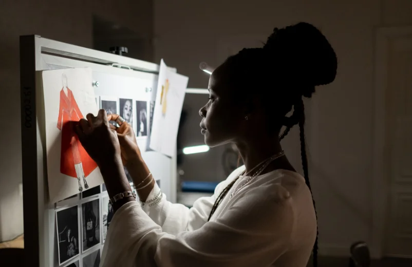 Designer pinning fabric and reference images to a mood board