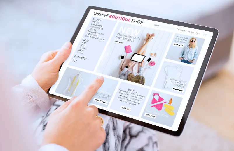 Hands browsing an online boutique store on a tablet