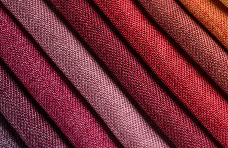 Folded fabrics in shades of red, wine and orange