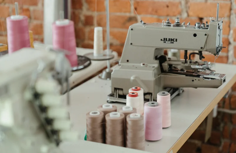 Juki industrial machine and thread cones in a small sewing workshop